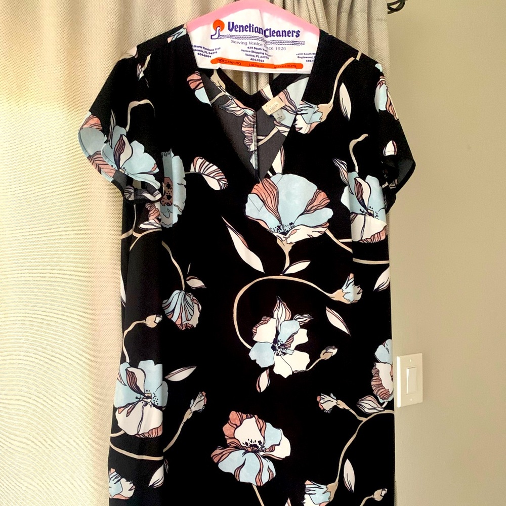 Knee length black floral dress. Loose fit. Size large. Worn once to a wedding.